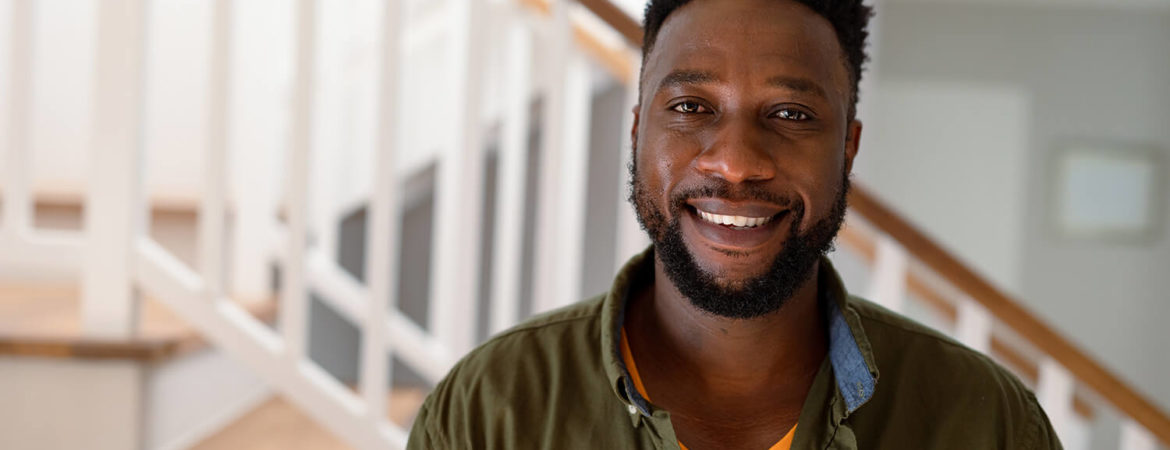 Headshot of Amir at his home, smiling.