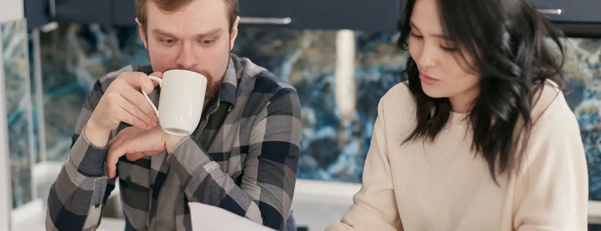 Couple researching debt settlement companies.